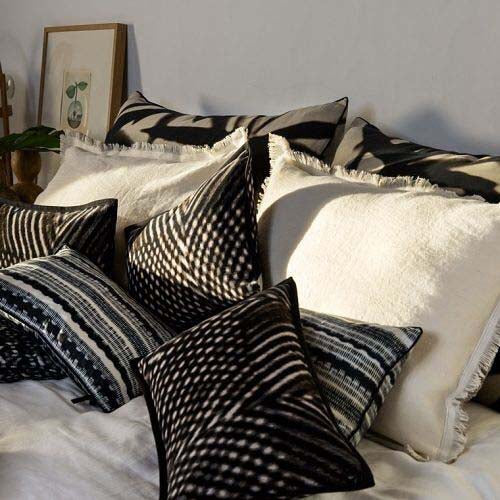 Aruba cushions with other Elitis Cushions on bed
