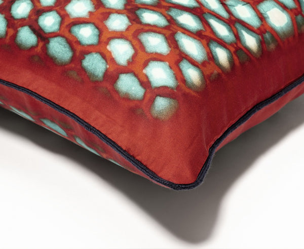 Close up of the Ambre red silk cushion