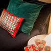 Ambre Cushion with other large cushions, and red cups