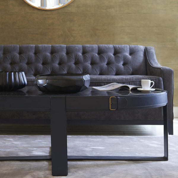 Camera Leather Buckle Oval Coffee Table modelled in a lounge scenario